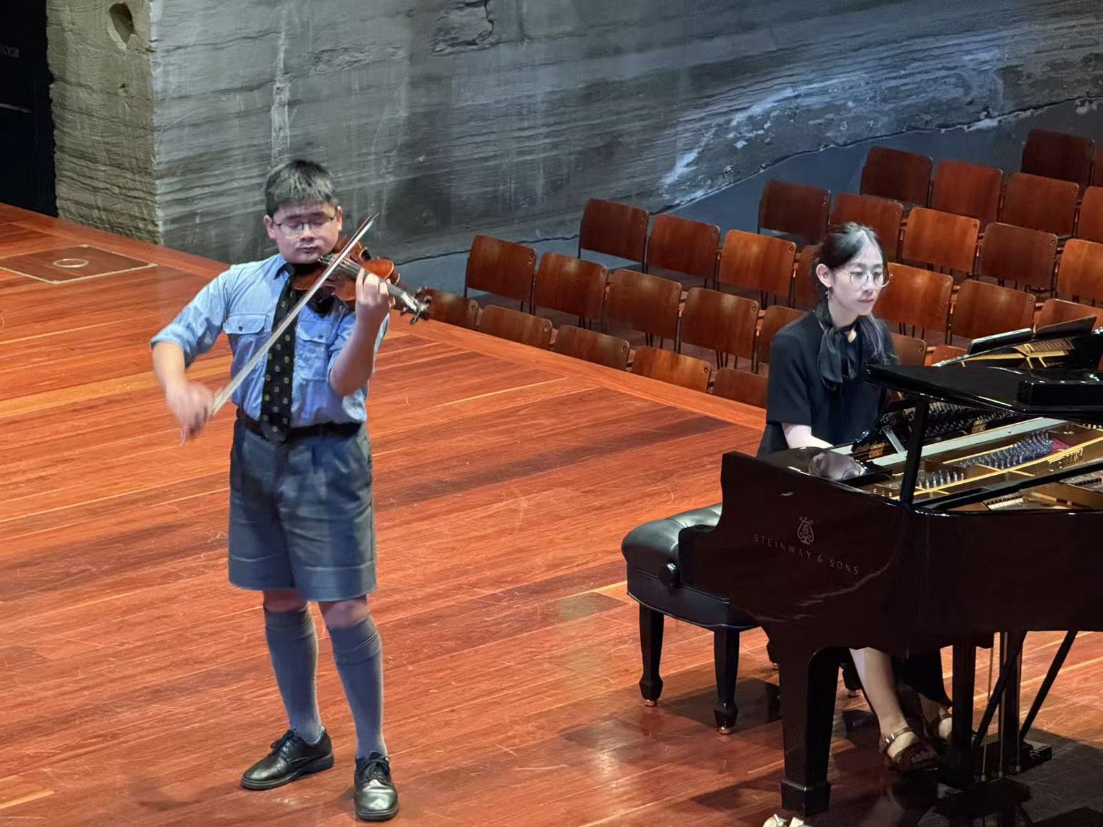 Vincent performing violin with a pianist at a scholars’ concert